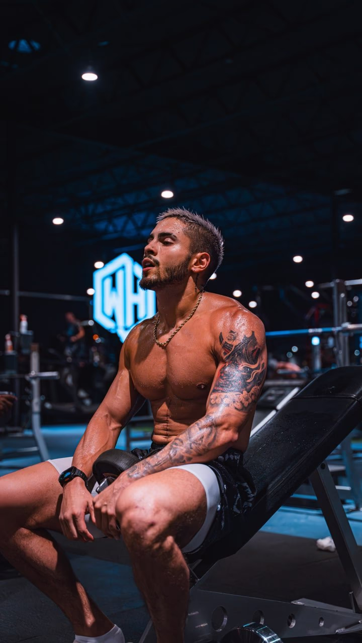 man flexing his muscles in a gym